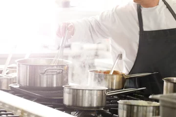 Foto auf Acrylglas Kochen Chef in hotel or restaurant kitchen cooking   