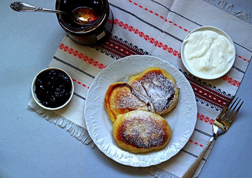 Pancakes with corn flour. Served with berry jam and sour cream