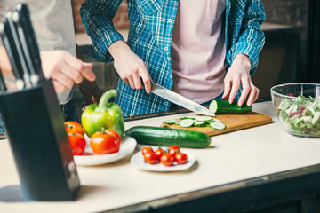 Family cook together in the kitchen.