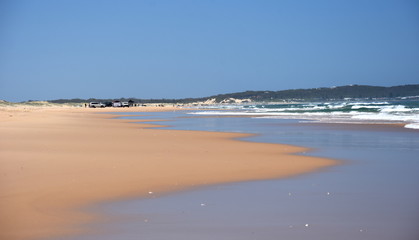 Horizontal landscape of the beach with cars. 4wd cars at Stockton beach (Anna bay, NSW, Australia).
