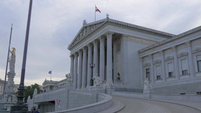 Austrian flag waving on top of the Austrian Parliament