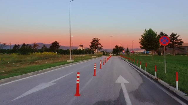Road construction work signalization with many traffic cone signs On asphalt at sunrise, cinematic shot