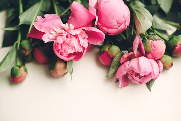 lovely pink peonies on rustic white wooden background top view, space for text. floral greeting card, flat lay. beautiful peony flowers pattern, tender image. happy mothers  day concept © sonyachny