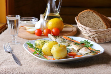 Baked pike with carrots and boiled potatoes.