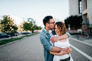 Fototapeta premium Romantic young couple in love, hugging on the street.