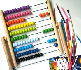 Children's multicolored abacus, pencils, markers