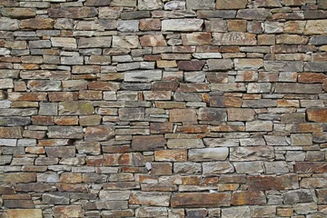 Foto op Canvas Stacked stone wall background © jcg_oida