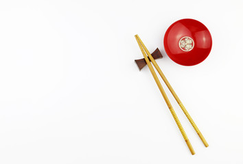 wood Chopsticks and Red bowl for sushi on White background Copy space