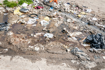 Big pile of junk and garbage dumped in the nature or park in the city polluting the environment with bad smell