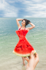 Naklejka na ściany i meble Young attractive woman on the beach relaxing. Pretty woman with watermelon. Cute girl outdoors