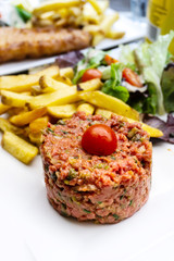 tasty Steak tartare (Raw beef) - classic steak tartare on white plate