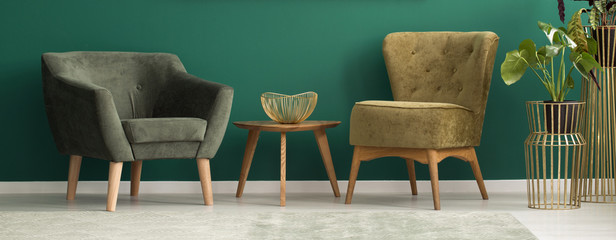 Upholstered chairs in green interior