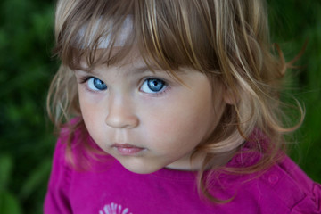Close-up portrait of a serious child. Without a smile.