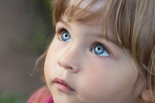 Close-up portrait of a beautiful child. Big Blue eyes