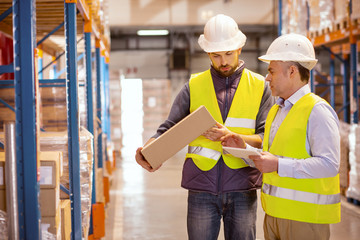 For shipping. Nice serious men checking the boxes while preparing them for shipping