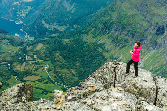 Tourist woman on Dalsnibba viewpoint Norway
