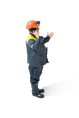 The studio shot of senior bearded male miner standing at the camera on a white background.