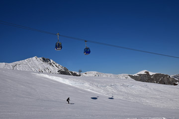 Télécabines et skieur dans l'Oberland bernois en Suisse