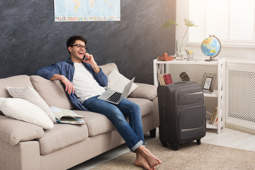 Excited man planning his annual vacation online