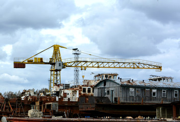 Fototapeta na wymiar industrial landscape: a crane in the old river port