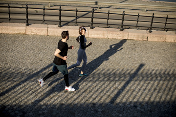 Healthy runners running in the city with cityscape background
