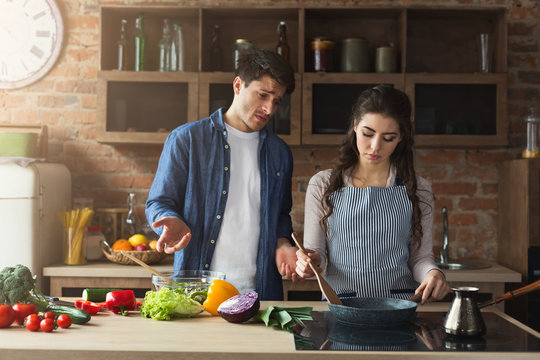 Couple cooking healthy dinner together