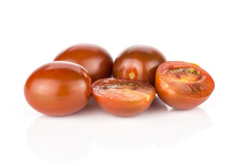 Black red grape cherry tomatoes stack isolated on white background.
