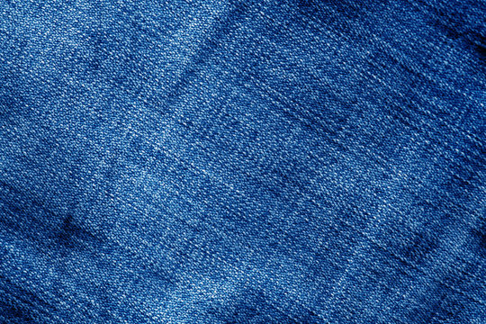 Jeans texture with blur effect in navy blue color.