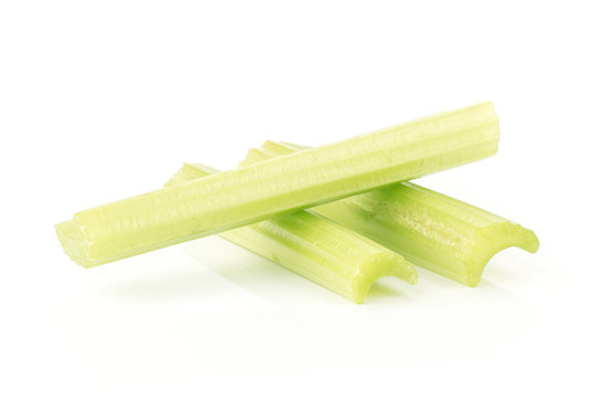 Three green celery sticks isolated on white background.
