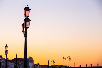 Fototapeta na wymiar Street lamp silhouette in Venice, Italy at sunrise