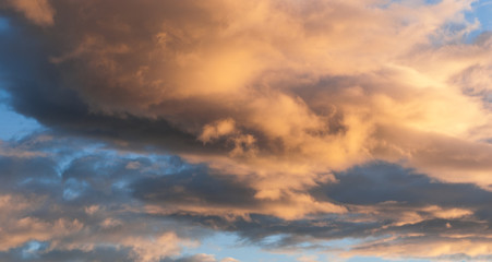 Gray, blue and orange cloud at sunset