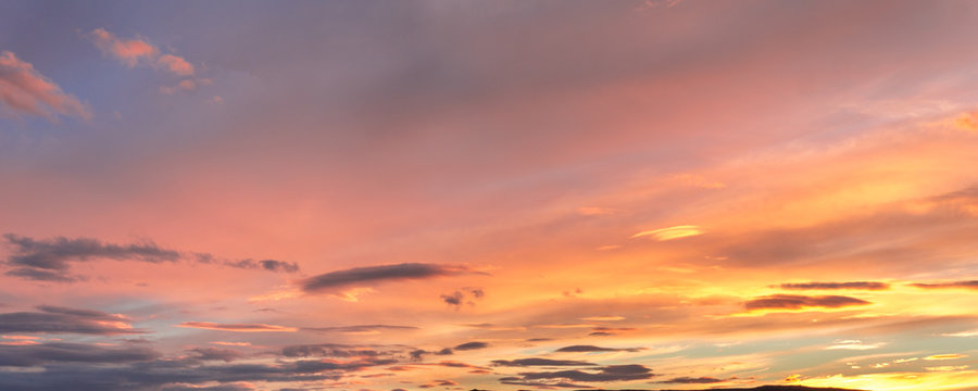 Fototapeta Gray, blue and orange cloud at sunset