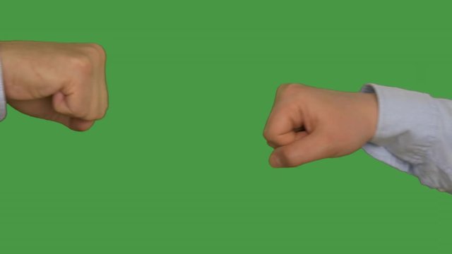 Businessman bumping fists with businesswoman, cropped view of hands. Alpha channel