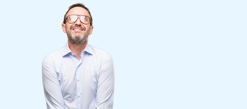 Middle age man with glasses thinking and looking up expressing doubt and wonder isolated over blue background