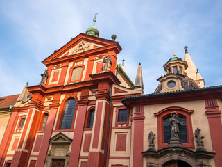 PRAGUE, CZECH REPUBLIC - FEBUARY 19, 2018 : St. George's Basilica in Prague Castle front view of the main entrance in Prague, Czech Republic.Blue sky sunny background winter season.Landmark historical