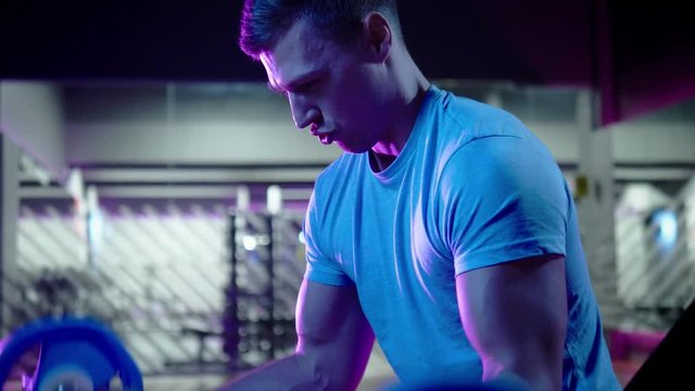 Man doing bodybuilding training in a gym.
