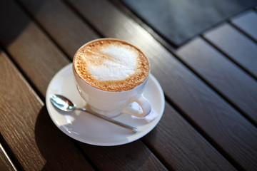 Cup of cappuccino on a wooden table