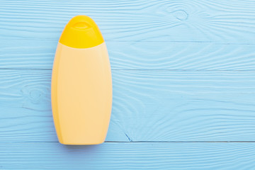 Sunscreen cream bottle on blue