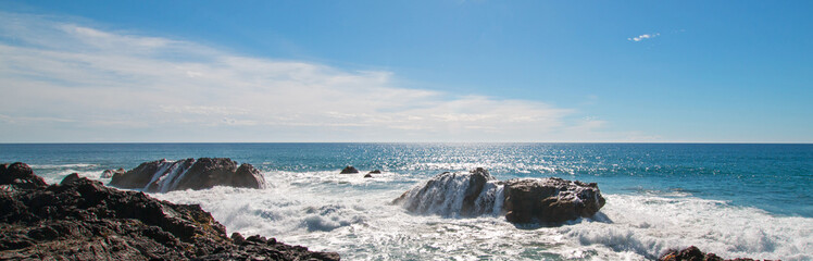 Waves breaking on rocky coast at Cerritos Beach between Todos Santos and Cabo San Lucas in Baja California Mexico BCS