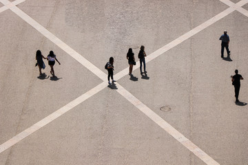Aerial view of a group of people walking in a square in the city of lisbon in Portugal - obrazy, fototapety, plakaty