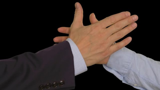 Two hands joining together after deal. Businessman and businesswoman shaking hands