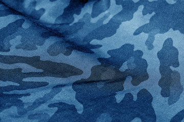 Military uniform pattern with blur effect in navy blue tone. © pavelalexeev