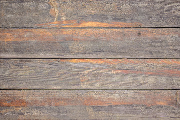 Texture from old wooden boards with traces of wiped orange paint_