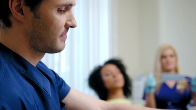 Dentist and his assitant working in private practice.