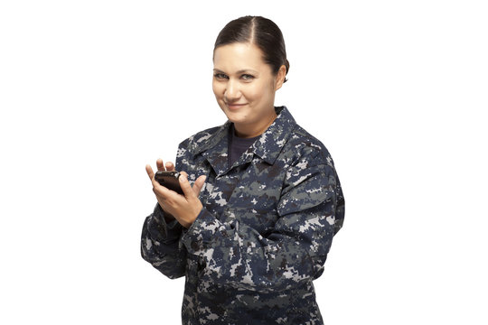 Portrait of female navy officer text messaging