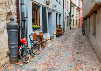Fototapeta na wymiar Morning in narrow medieval street in old city of Riga, Latvia, Europe. 