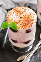 Delicious dessert with cream and canned cherry in a glass. Country style .Selective focus