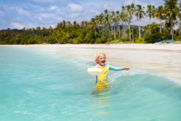 Naklejka premium Child on tropical beach. Sea vacation with kids.