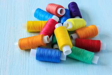 Coils of colorful sewing thread. Threads for sewing rainbow colors.