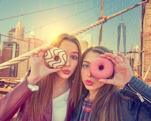 Teen girls portrait with donuts in eye New York